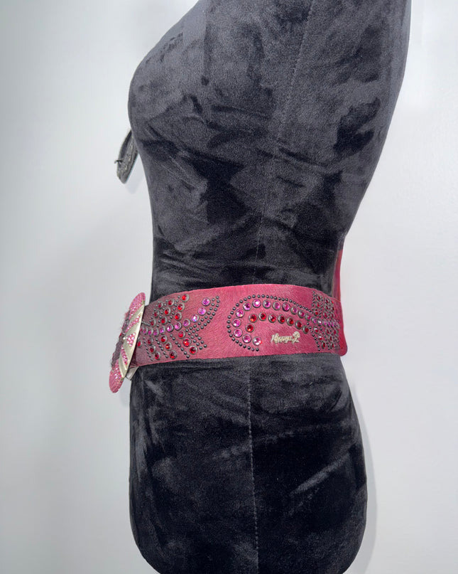 Burgandy hair hide Kippy dress with a pink belt featuring rhinestones on a white background